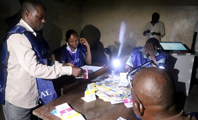 Agents of Congo's National Independent Electoral Commission (CENI) count casted ballot papers after election at a polling station in Kinshasa.