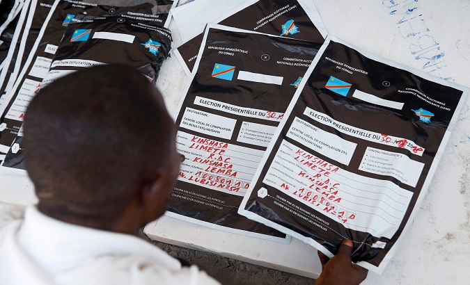A man reviews voting materials at a tallying center in Kinshasa, Congo, Jan. 3, 2019.
