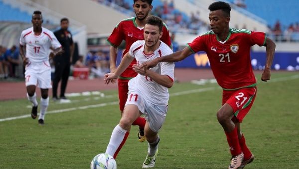 Oman fights for the ball with Palestine at the Vietnam Football Federation International U23 tournament, 2018.