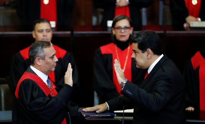Venezuela's President Nicolas Maduro is sworn in by Venezuela's Supreme Court President Maikel Moreno, during the ceremonial swearing-in for his second presidential term, at the Supreme Court in Caracas, Venezuela Jan. 10, 2019.