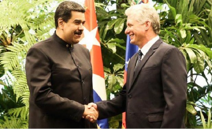 Venezuelan President Nicolas Maduro and Cuban leader Miguel Diaz-Canel share an embrace.