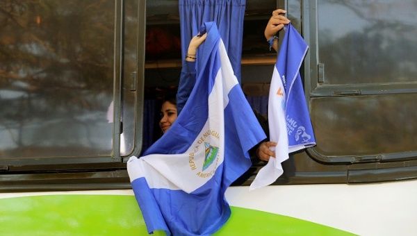 Catholic pilgrim holding a Nicaraguan flag before leaving to Panama for the third World Youth Day with Pope Francis.