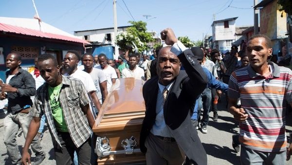 People carry the coffin of a victim of the Police crackdown in Port-au-Prince, Haiti, Feb. 22, 2019.