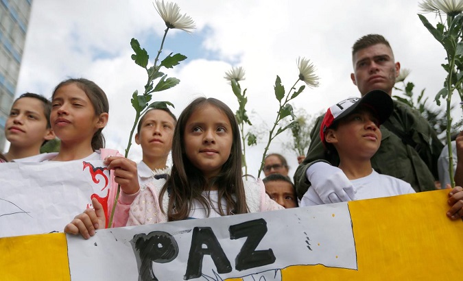 FILE PHOTO: People take part in a rally against violence, following a car bomb explosion, in Bogota, Colombia January 20, 2019. The placard reads, 