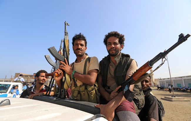Houthi militants withdrawing on the back of a truck, part of a U.N.-sponsored peace agreement signed in Sweden earlier this month, Dec. 29, 2018