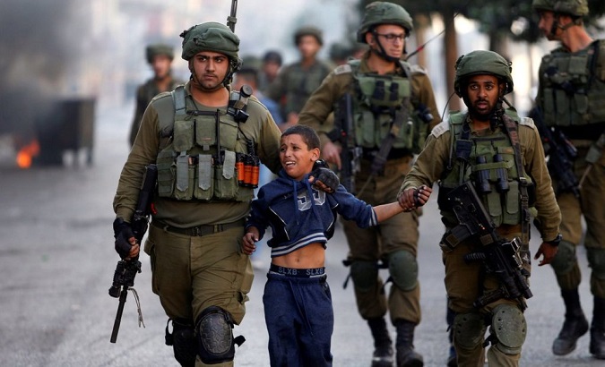 Israeli soldiers detain a Palestinian boy during clashes in the West Bank.