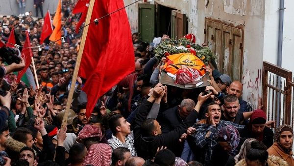 Mourners carry the body of Palestinian volunteer paramedic Sajed Mezher, a victim killed by Israeli troops, during his funeral in Bethlehem in the Israeli-occupied West Bank March 27, 2019.