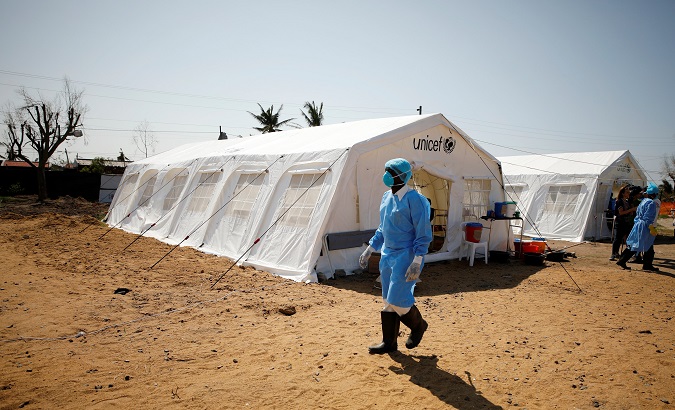 Medical staff wear protective masks at a cholera treatment center.