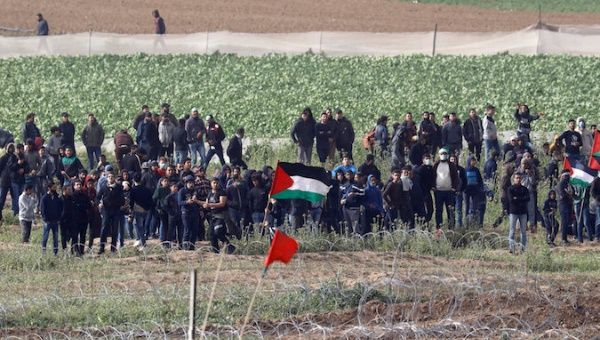 Palestinians gather near the border fence between Israel and the Gaza Strip during a protest, as it is seen from its Israeli side