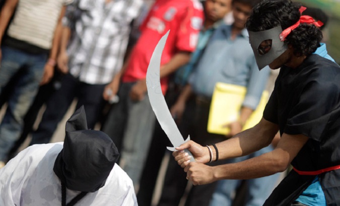 Demonstrators stage a mock beheading to protest the executions in Saudi Arabia