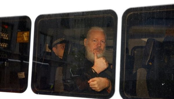WikiLeaks founder Julian Assange is seen in a police van after was arrested by British police outside the Ecuadorian embassy in London, Britain April 11, 2019. 