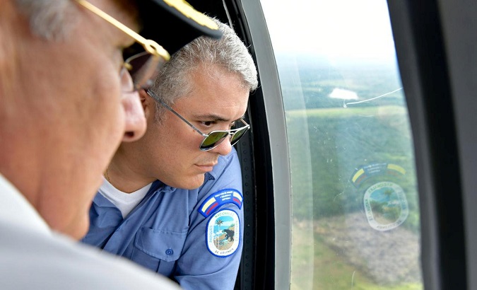 President Ivan Duque flies in a helicopter over Chiribiquete Mountains in Colombia, April 28, 2019.