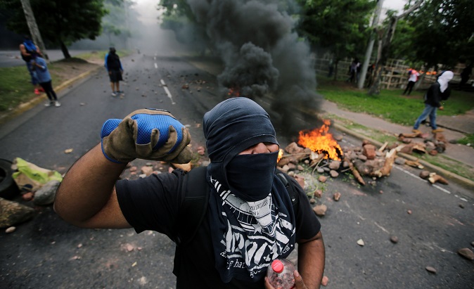 A masked demonstrator during a protest against the government of Honduras' President Juan Orlando Hernandez, in Tegucigalpa, Honduras June 20, 2019.