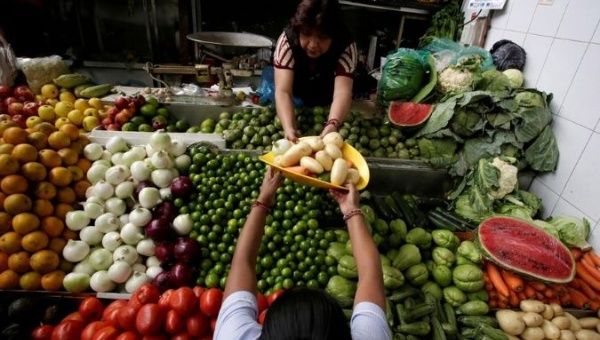  A woman buys vegetables at a market stall in Mexico City, Mexico February 22, 2019. 