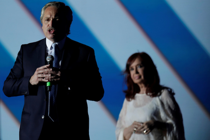 Argentina's President Alberto Fernandez speaks next to Vice President Cristina Fernandez de Kirchner on stage outside the Casa Rosada Presidential Palace after inauguration, in Buenos Aires, Argentina December 10, 2019.