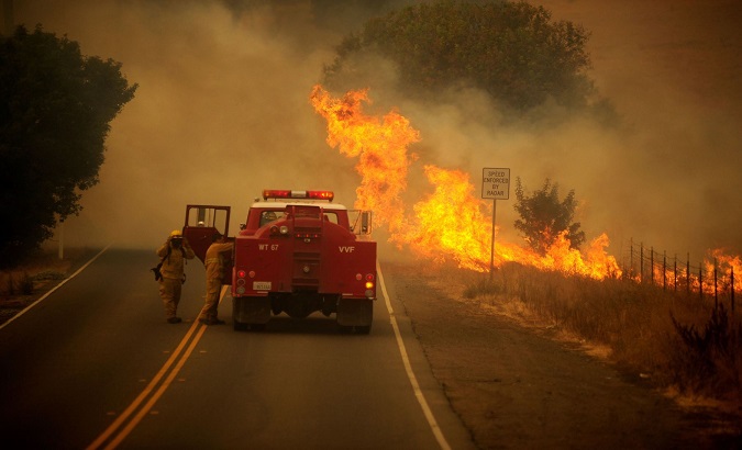Firefighters try to extinguish the flames in California, U.S., August 19, 2020.