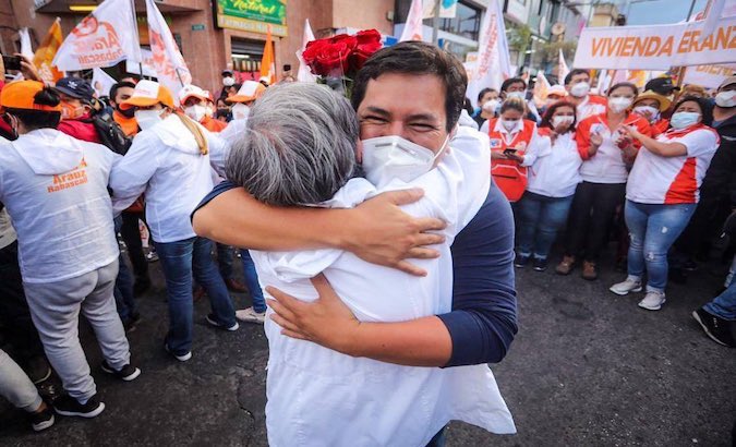 Andres Arauz hugs a supporter in Quito, Ecuador, Jan. 28, 2021.