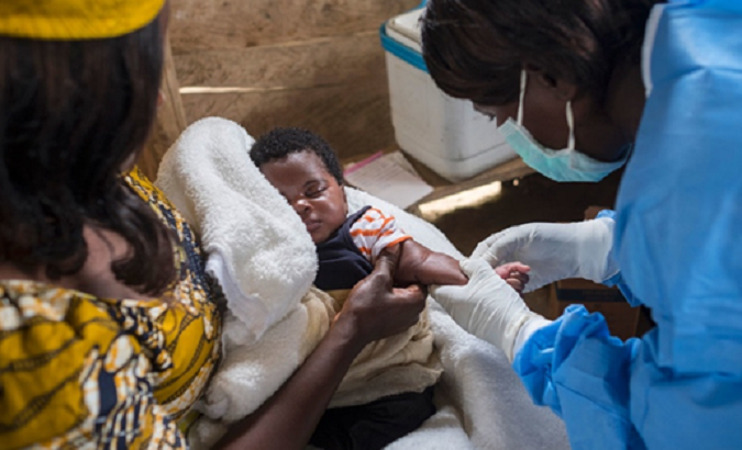File photo shows a nurse preparing to vaccinate an infant in North Kivu, the Democratic Republic of the Congo.
