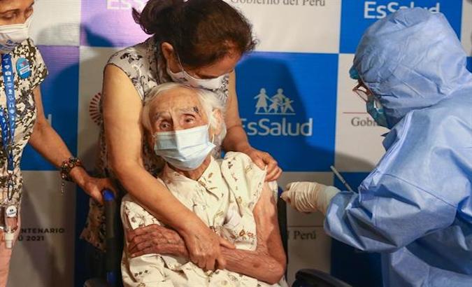 An elderly woman receives a COVID-19 vaccine in Lima, Peru, April 2021.