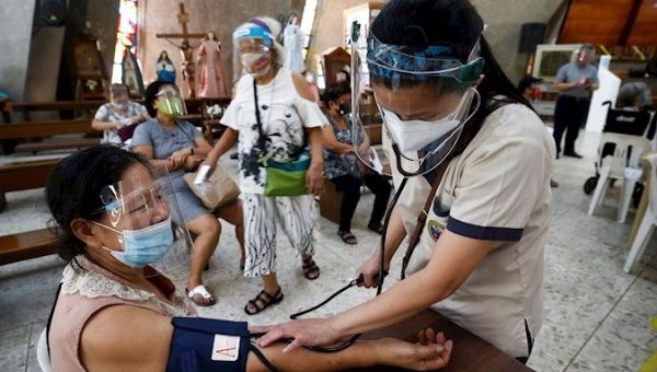 Woman undergoes post-vaccination monitoring, Quezon City, Philippines, May 21, 2021. 