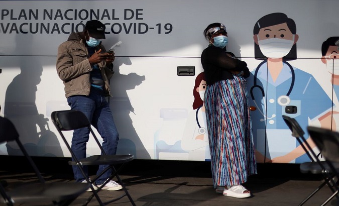 People wait outside a mobile vaccination center, Santiago, Chile, Jun. 16, 2021.