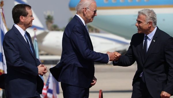 Israeli President Issac Herzog (L) and Prime Minister Yair Lapid (R) welcome U.S. President Joe Biden at Ben Gurion Airport in Tel Aviv, Israel, July 13, 2022.