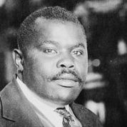 Marcus Garvey, National Hero of Jamaica, featured seated at his desk in 1924 (Photo: USLOC).