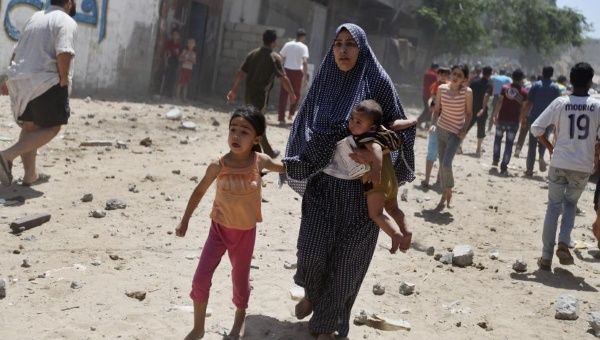 A Palestinian woman fleeing a bomb attack in Gaza.