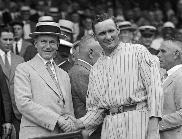 US President Calvin Coolidge and Washington Senators pitcher Walter Johnson shake hands, 1924 (Photo: Wikimedia Commons)