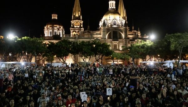 People gather outside Guadalajara Cathedral in support of the Ayotzinapa Teacher Training College missing students. Thousands marched across Mexico on Wednesday to demand the government find out what happened to dozens of missing students. The students from a teachers' college went missing after they clashed with police in Iguala on September 26 (Photo: Reuters). 