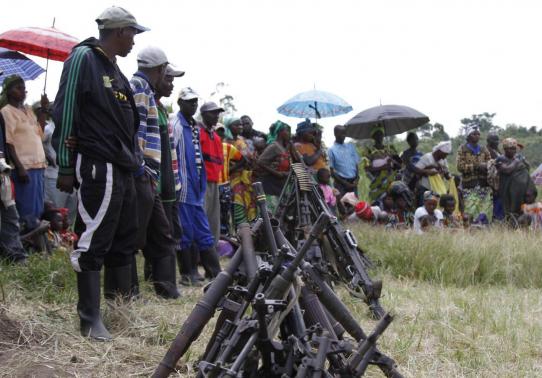 Militants from the Democratic Forces for the Liberation of Rwanda (FDLR) stand near a pile of weapons after their surrender in Kateku, a small town in eastern region of the Democratic Republic of Congo (DRC), May 30, 2014. (Photo: Reuters/Kenny Katombe)