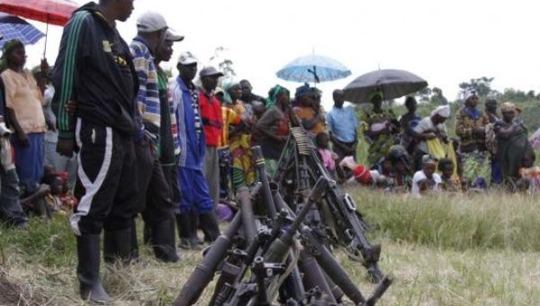Militants from the Democratic Forces for the Liberation of Rwanda (FDLR) stand near a pile of weapons after their surrender in Kateku, a small town in eastern region of the Democratic Republic of Congo (DRC), May 30, 2014. (Photo: Reuters/Kenny Katombe)  