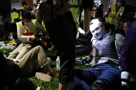 Medics care for protesters who were injured on Sunday night in clashes with police that lead into Monday morning in the disctrict of Admiralty, Hong Kong. (Photo: Reuters)