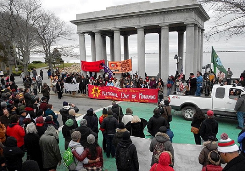Members and supporters of the United American Indians of New England gather around Plymouth Rock to honor the National Day of Mourning event they have organized for the last 45 years. (Photo: Liza Green)
