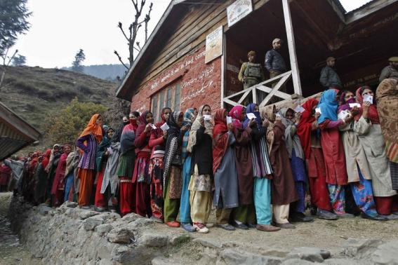 Voters line up to cast their votes outside a polling station during the first phase of the Jammu and Kashmir state assembly elections at Baba Nagri November 25, 2014.