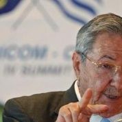 Cuba's president Raul Castro, with CARICOM and Cuban flags in the background. Deepening ties with Cuba has become a priority for CARICOM