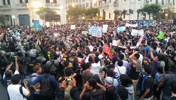 Demonstrators push against a police barricade