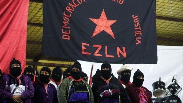 Zapatistas stand under the Zapatista flag during 20th anniversary celebrations of the armed indigenous insurgency in Oventic December 31, 2013.
