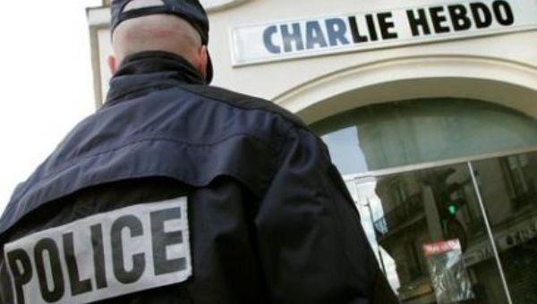 A policeman stands guard outside the French satirical weekly Charlie Hebdo in Paris in this 2006 file photo.