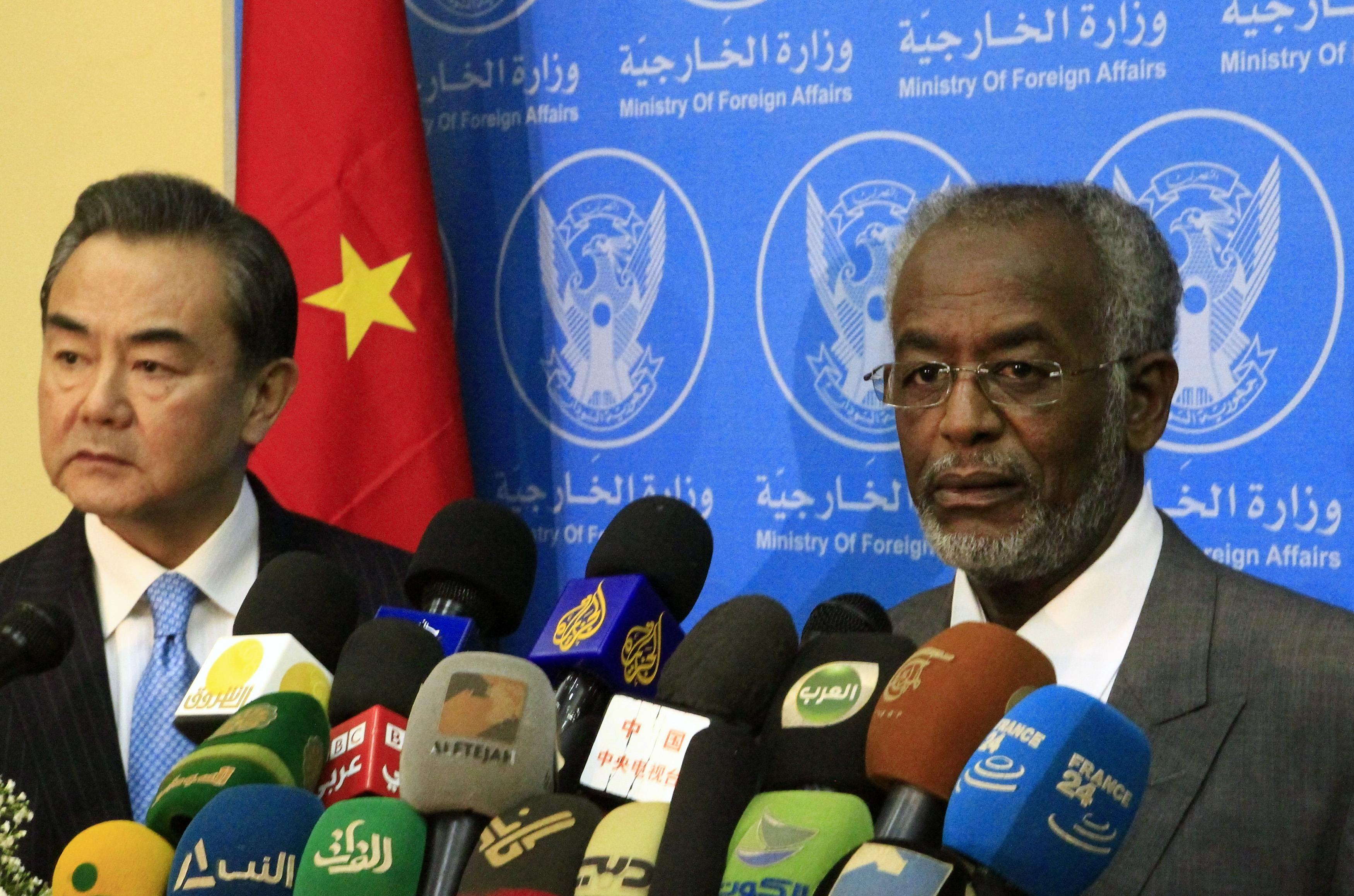 Sudan's Foreign Minister Ali Karti (R) speaks next to China's Foreign Minister Wang Yi during a joint news conference in Khartoum January 11, 2015