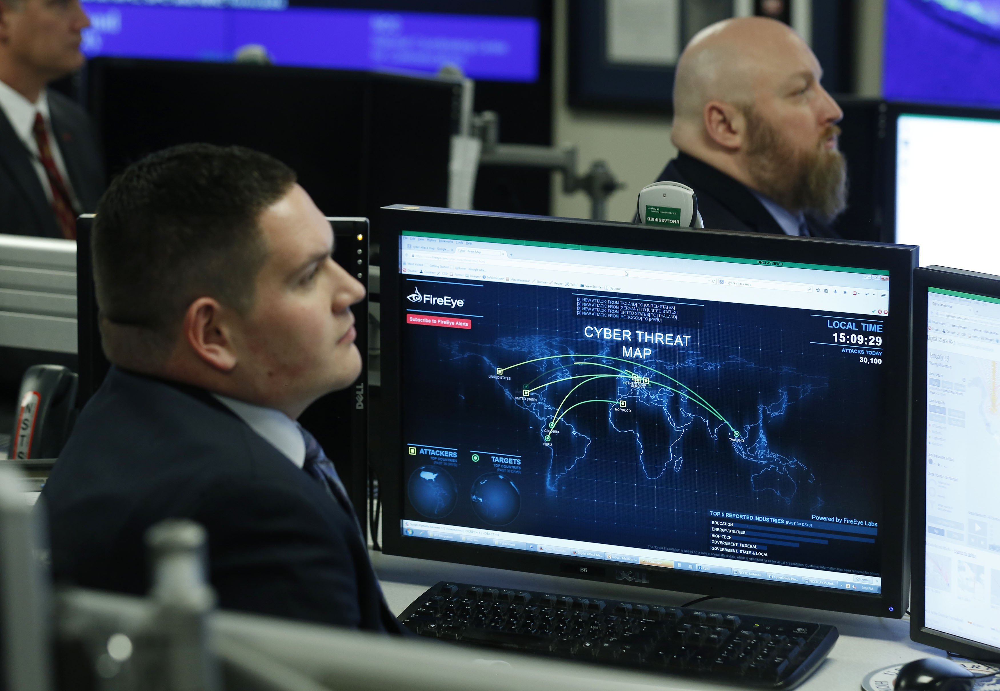 A Department of Homeland Security worker listens to U.S. President Barack Obama talk at the National Cybersecurity and Communications Integration Center in Arlington, Virginia, January 13, 2015