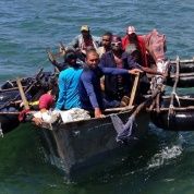Cubans sit aboard a homemade raft, known in Cuba as a balsa.