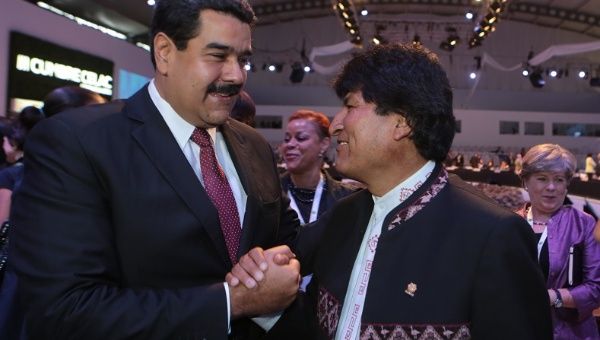 Venezuelan President Nicolas Maduro greets his Bolivian counterpart, Evo Morales, at the closing of the 3rd CELAC summit on Jan. 29, 2015.