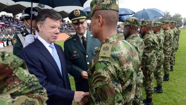 Colombian President Juan Manuel Santos greets military personnel.