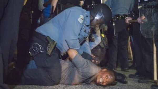 Police arrests a protestor outside the City of Ferguson Police Department and Municipal Court in Ferguson, Missouri, March 11, 2015, hours before two police officers were shot. 