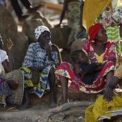 Women displaced as a result of Boko Haram attacks in the northeast region of Nigeria sit together at a camp for internally displaced people January 14, 2015.