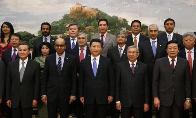 China's President Xi Jinping (front C) poses for photos with guests at the Asian Infrastructure Investment Bank launch ceremony at the Great Hall of the People in Beijing Oct. 24, 2014.