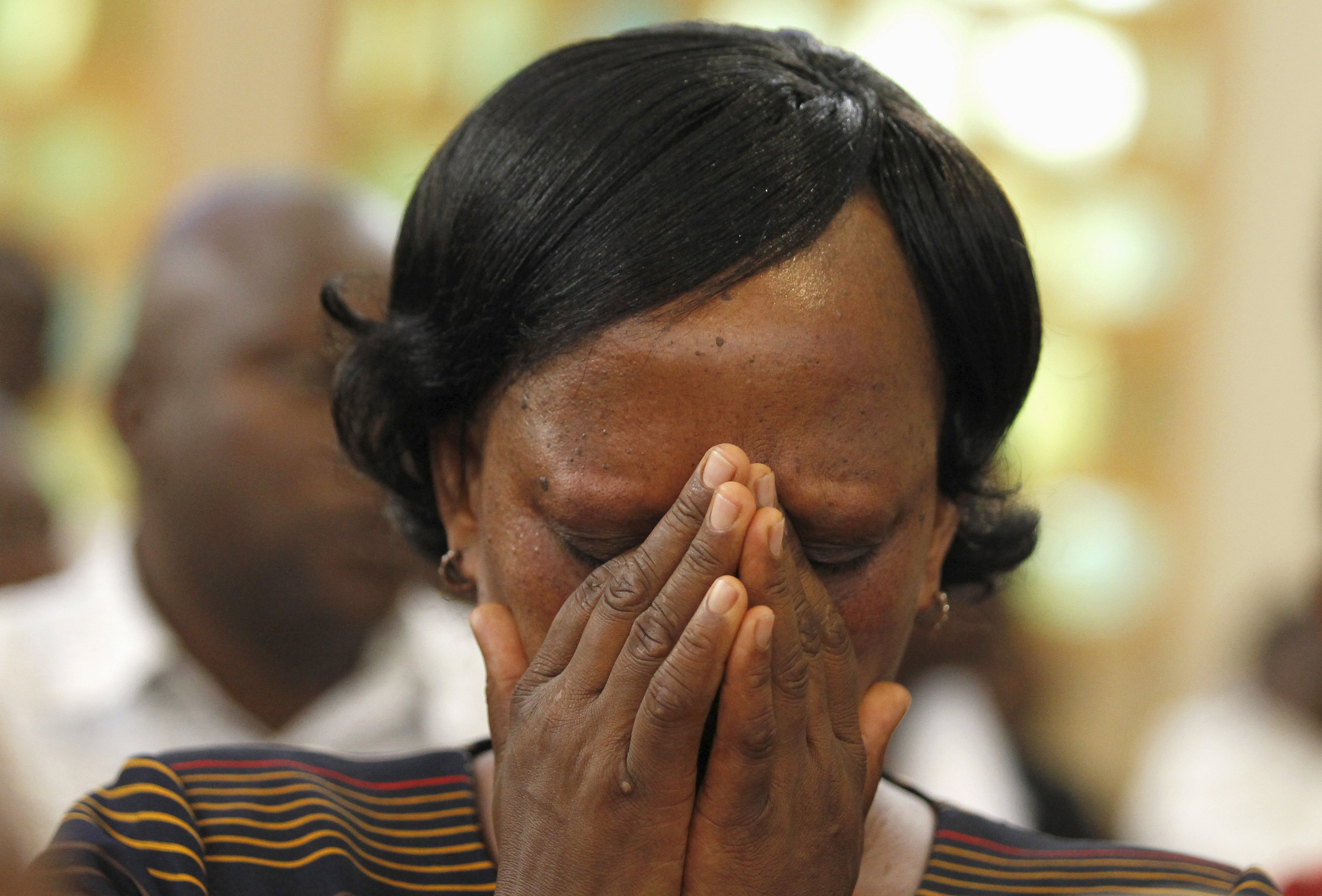 A person prays during a special Easter mass at the Holy Family Basilica Catholic Church for the victims of the Garissa University attack in Kenya's capital Nairobi.