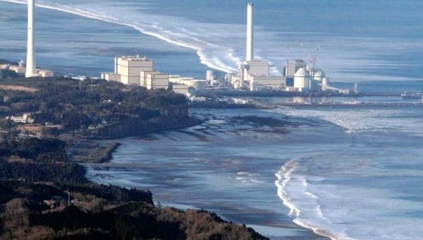 Hirono Power Station is seen as a wave approaches after an earthquake in Fukushima Japan, March 11, 2011.