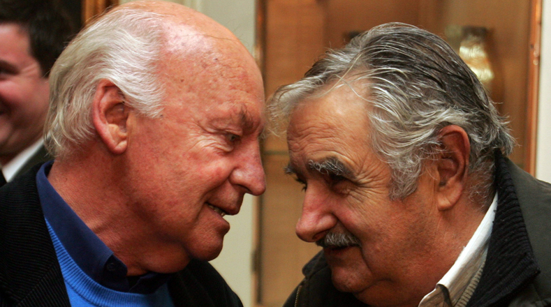 Galeano expressed admiration for Uruguayan President Jose Mujica (R). This photograph was taken when Galeano received the Argentine Order of May at the country's embassy in Uruguay. Galeano was internationally renowned and received numerous awards.